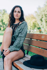 Portrait of young woman sitting on field