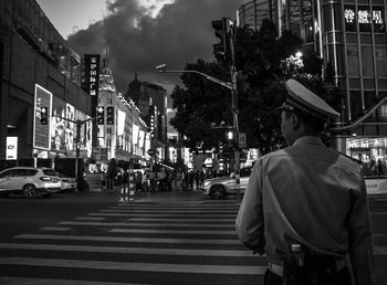 Police man standing on road in city