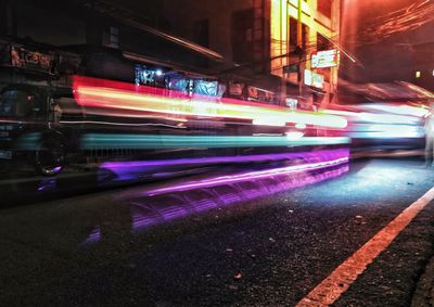 Light trails on road in city at night