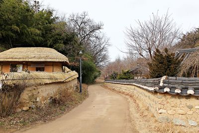 Road amidst buildings against clear sky