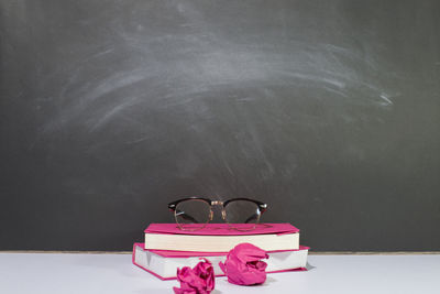 Close-up of sunglasses on table against wall