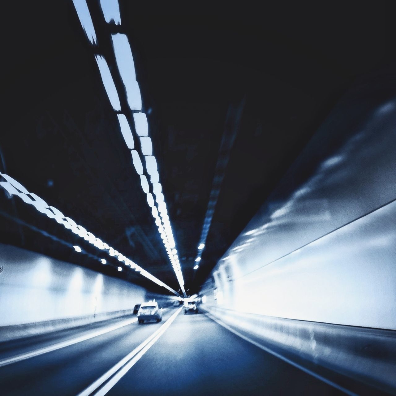 transportation, the way forward, road, diminishing perspective, road marking, vanishing point, connection, tunnel, bridge - man made structure, mode of transport, on the move, car, land vehicle, illuminated, highway, motion, indoors, engineering, travel, built structure