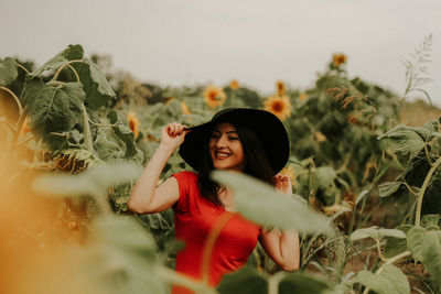 Young woman standing at sunflower farm