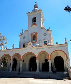 Low angle view of bell tower against blue sky