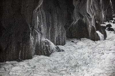 Volcanic rock cliff with splashing sea water in ponta da ferraria, san miguel, azores, portugal