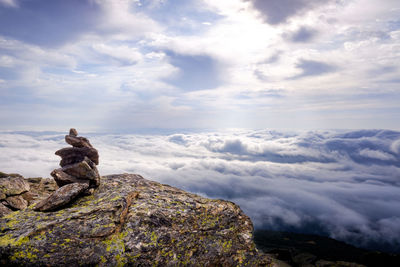 Stack of rocks on mountain against sky