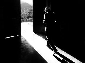 Full length of woman standing against wall