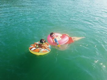 High angle view of children swimming in sea