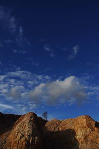 Low angle view of rock formation against sky