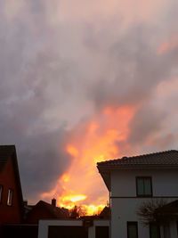 Low angle view of buildings against sky during sunset