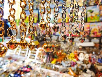 Close-up of decorations hanging in store for sale