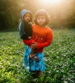 Portrait of girl standing on field