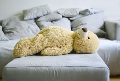 Stuffed toy on sofa at home