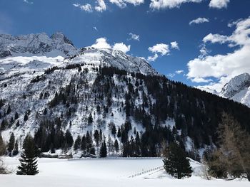 Scenic view of snow covered mountains against sky