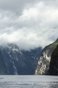 Scenic view of sea and mountains against sky