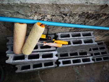 High angle view of yellow metallic structure against wall