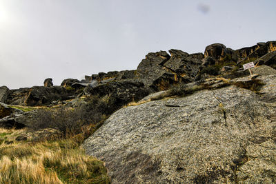 Low angle view of rock formations against sky