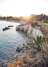 Scenic view of river against sky during sunset