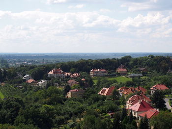 Aerial view of town by sea against sky