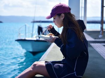 Side view of woman sitting on boat