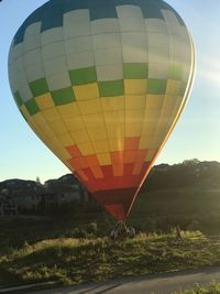 Hot air balloon flying over field