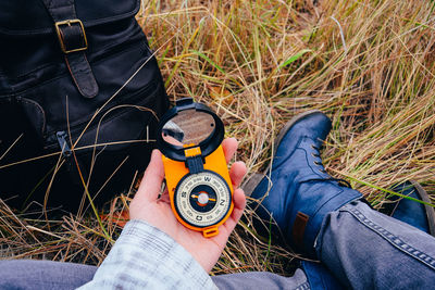 Close-up of hand holding navigational compass