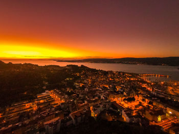 High angle view of illuminated buildings against sky during sunset