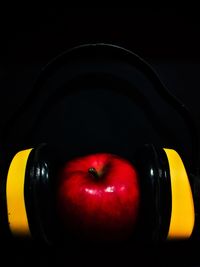 Close-up of apple on table against black background