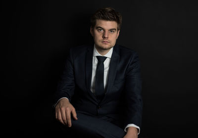 Portrait of businessman on black background