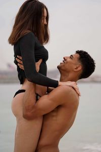 Side view of man lifting up his girlfriend