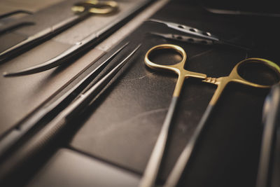 High angle view of scissors with equipment on table