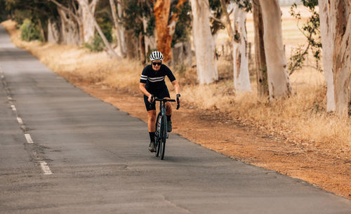 Woman riding bicycle on road