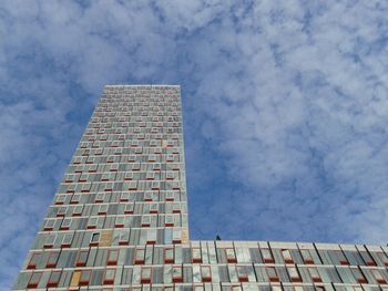 Low angle view of building against cloudy sky