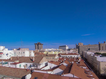 High angle view of townscape against blue sky