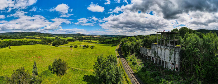 Panoramic shot of trees and buildings against sky