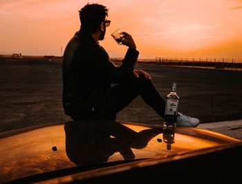 Side view of a man drinking water