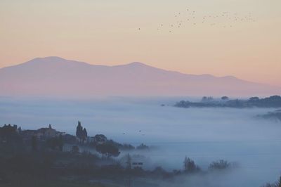 Scenic view of lake against sky during sunset
