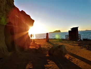 Scenic view of beach against sky during sunset