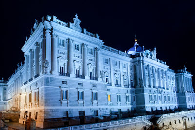 Low angle view of illuminated building at night