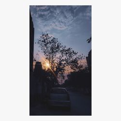 Car in city against sky at sunset