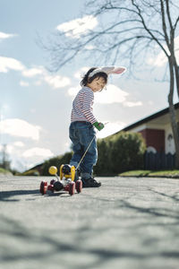 Rear view of boy playing with umbrella