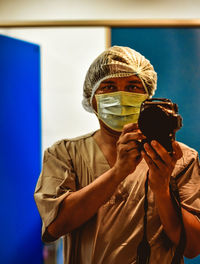 Portrait of surgeon taking selfie with camera