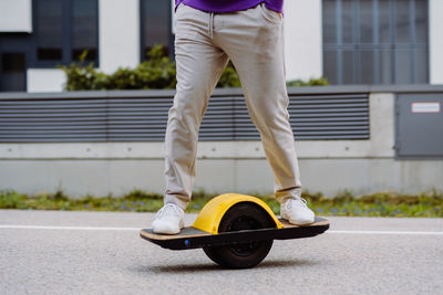 Side view of man skateboarding on road