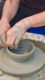 Midsection of person working in mud