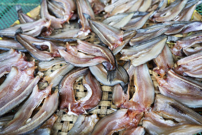 Dried fish on the bamboo grid in the sunny day