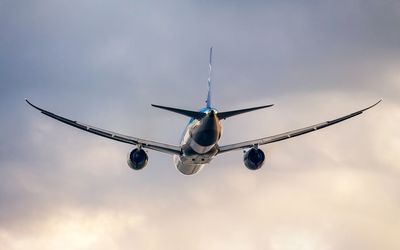 Low angle view of airplane flying against sky