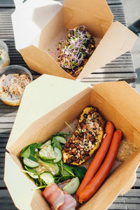 High angle view of food in box outside, take away breakfast.