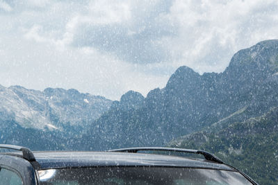 Scenic view of mountains seen through car windshield