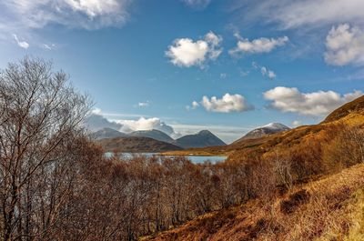 Scenic view of lake against cloudy sky