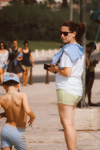 Mother and son standing at beach